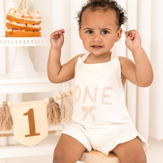 Baby First Birthday 'One' knitted frill and bow detail romper